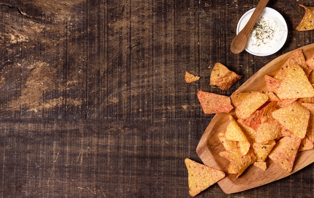 Flat lay of nacho chips with sauce