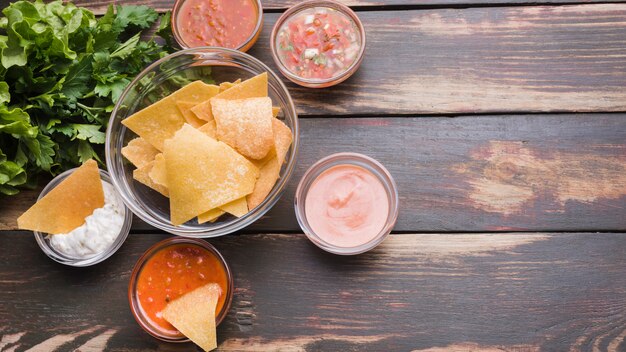 Flat lay of Nachos, salad and sauces