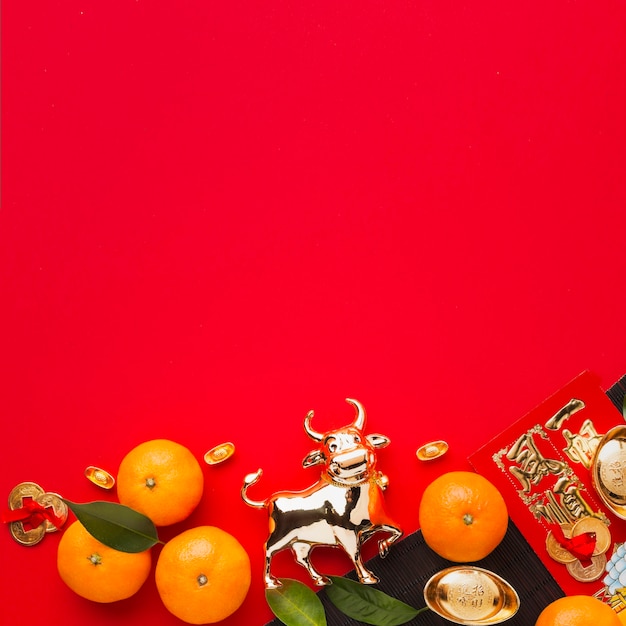 Flat lay new year chinese 2021 oranges and golden ox