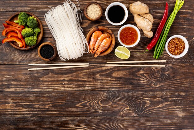 Flat lay noodles spices and chopsticks with copy space