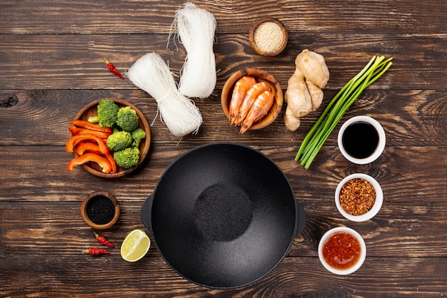 Flat lay noodles spices and chopsticks with plate