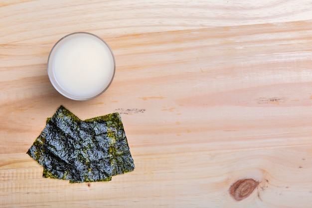 Flat lay nori seaweed and bowl with copy space