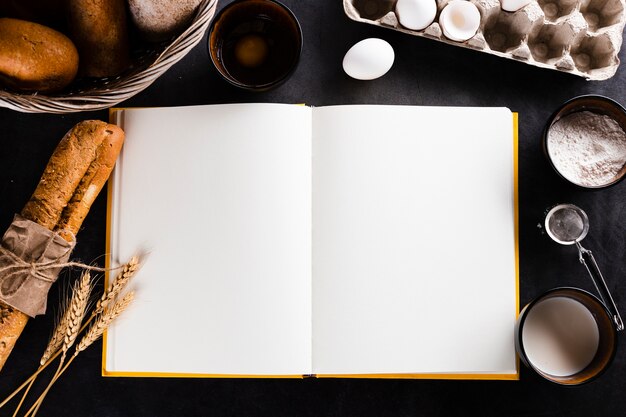 Flat lay of notebook and bread ingredients