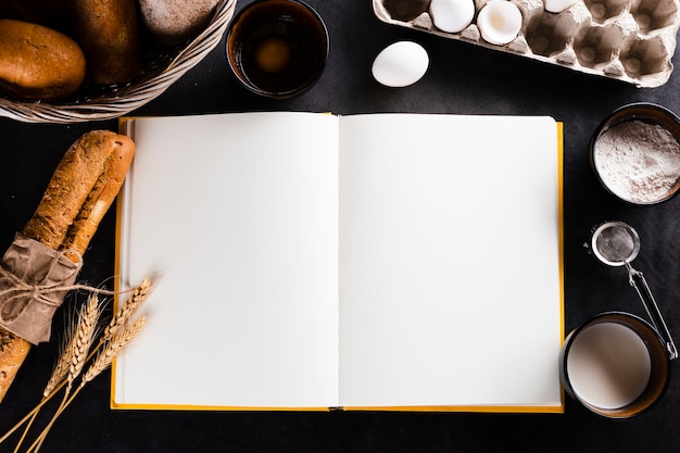 Flat lay of notebook and bread ingredients