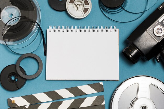 Flat lay notebook and cinema equipment