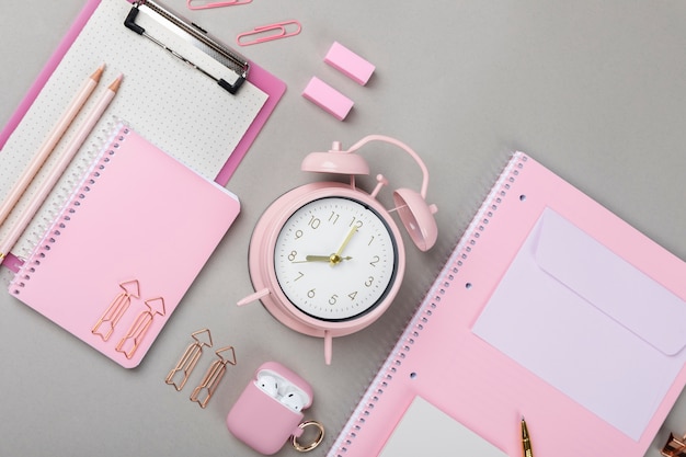 Free photo flat lay notebook and clock arrangement