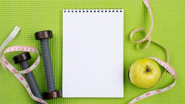 Flat lay notebook on green background