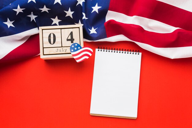 Flat lay of notebook with american flag and date