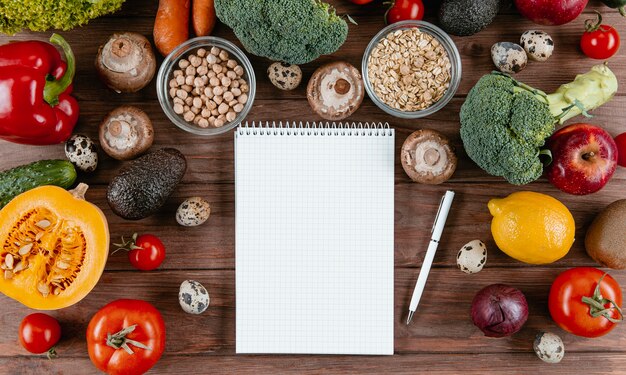 Flat lay of notebook with assortment of vegetables