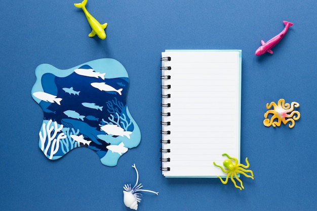 Flat lay of notebook with fish