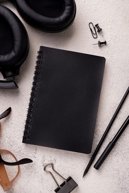 Flat lay of notebook with headphones