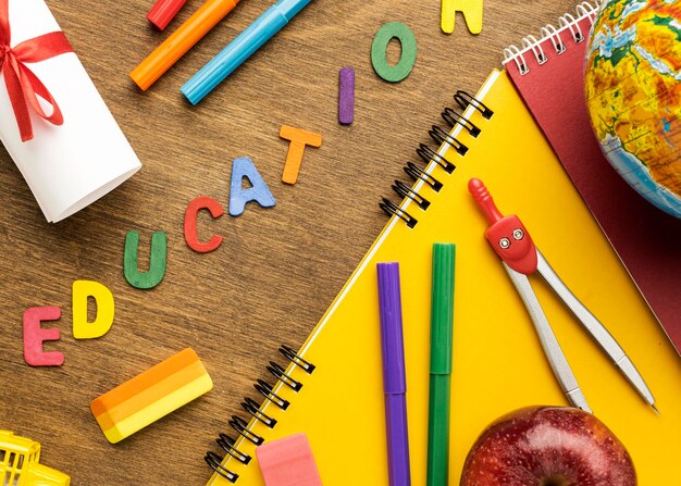 Flat lay of notebook with school supplies