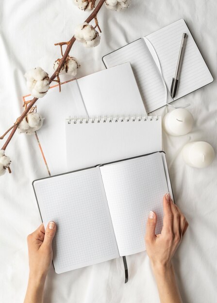 Flat lay notebooks and cotton arrangement