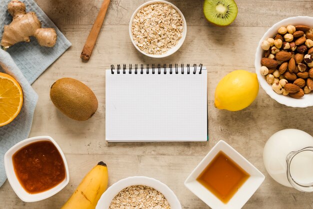 Flat lay nuts mix with fruits and oats and notebook