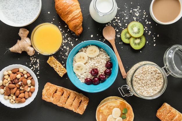 Flat lay oats and fruits with . pastry and orange juice