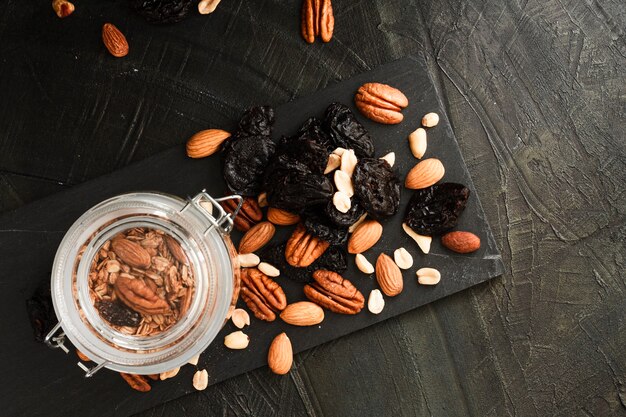 Flat lay oats jar with nuts mix and dates