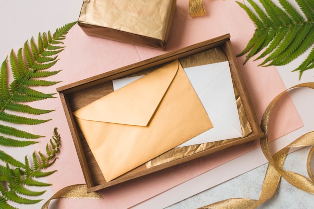 Бесплатное фото Плоская кладка конвертов в ящик с подарком