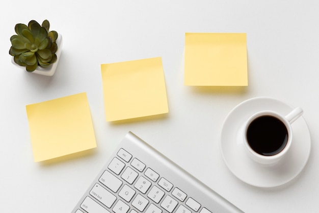 Free photo flat lay office desk assortment with empty post its