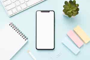 Free photo flat lay office desk composition with phone