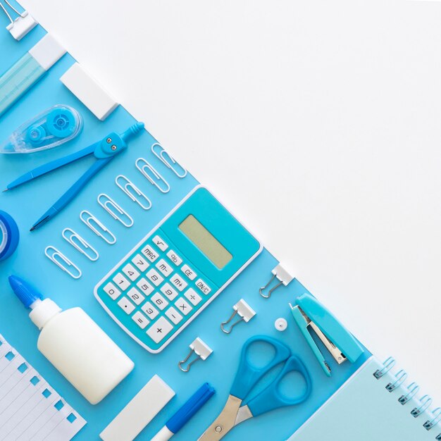 Flat lay of office stationery with calculator and copy space