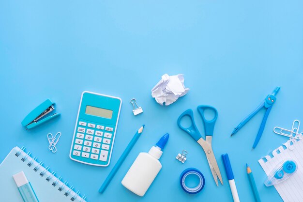 Flat lay of office stationery with calculator and correction fluid