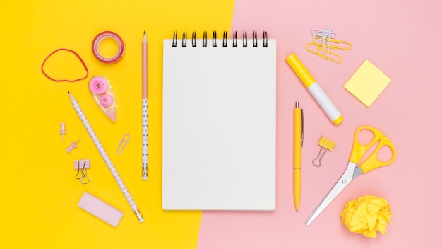 Flat lay of office stationery with notebook and elastic bands