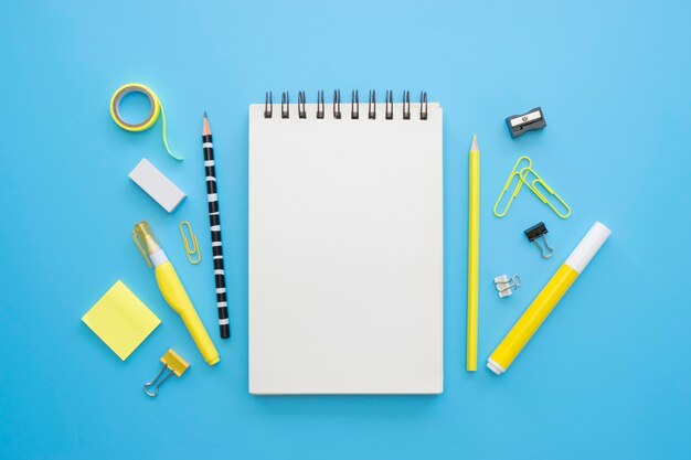 Flat lay of office stationery with notebook and sticky notes