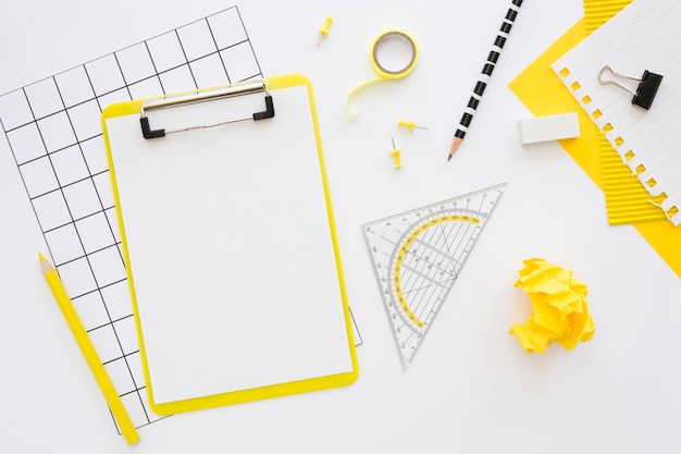 Flat lay of office stationery with notepad and crumpled paper