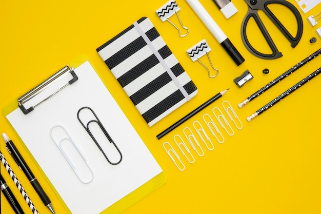 Flat lay of office stationery with paper clips and notepads