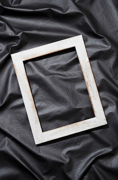 Free photo flat lay old frame on dark background