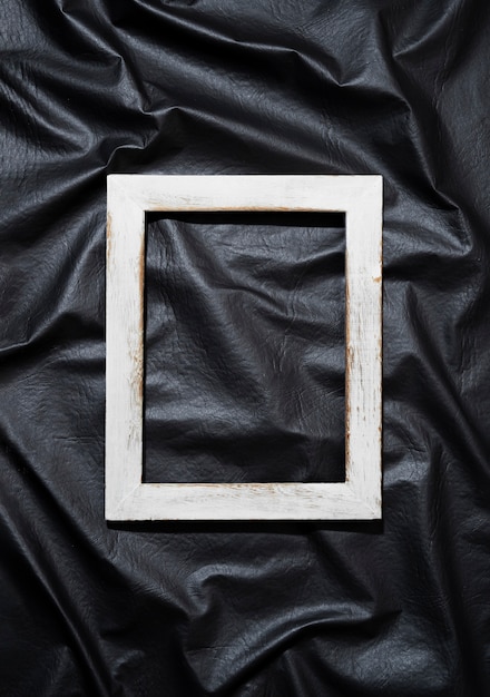 Free photo flat lay old white frame on dark background