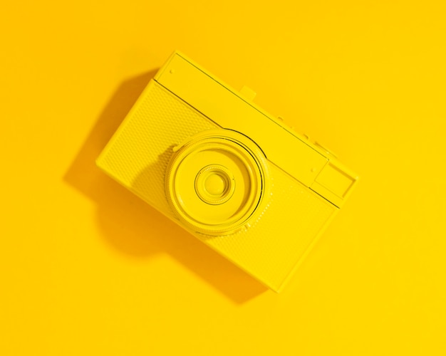 Flat lay old yellow camera