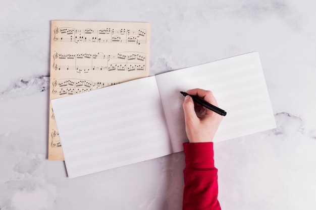 Flat lay of open book for music notes