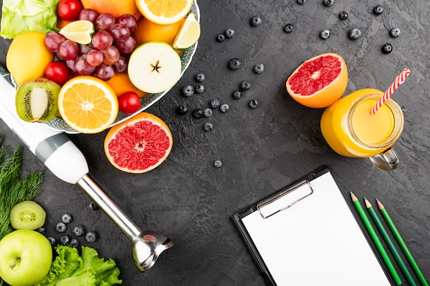 Flat lay orange juice and bowl of fruit