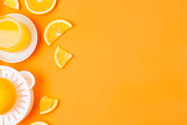 Flat lay orange juice on orange background with copy space