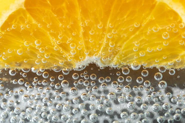 Free Photo flat lay orange slice and sparkling water
