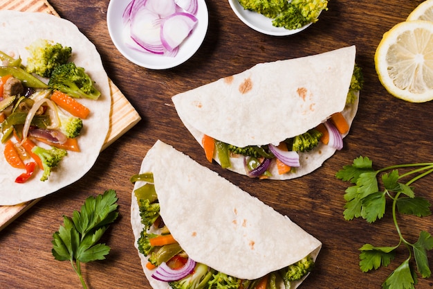 Flat lay of organic vegetables wrapped in pita
