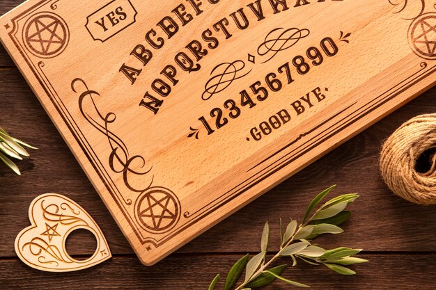 Flat lay ouija board and leaves