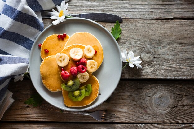 Flat lay pancakes with mix of fruits