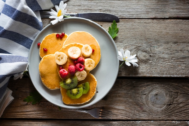 Flat lay pancakes with mix of fruits