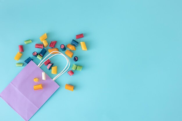 Flat lay paper bag and chewing bags on a blue background