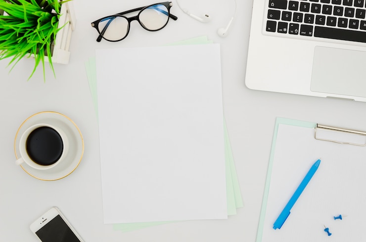 Free Photo flat lay paper mockup next to laptop