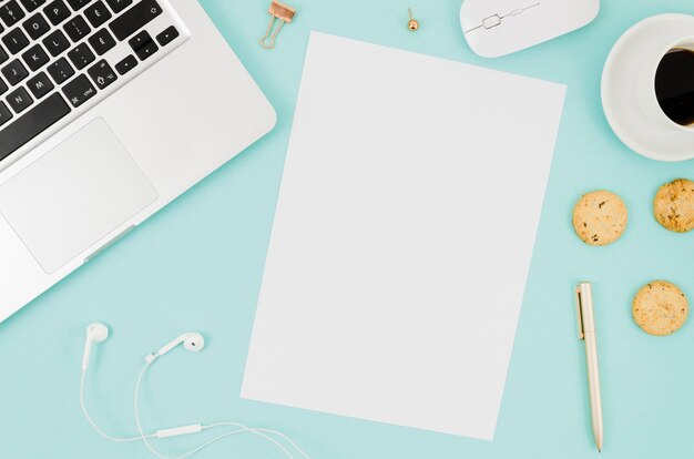 flat lay paper mockup next to laptop