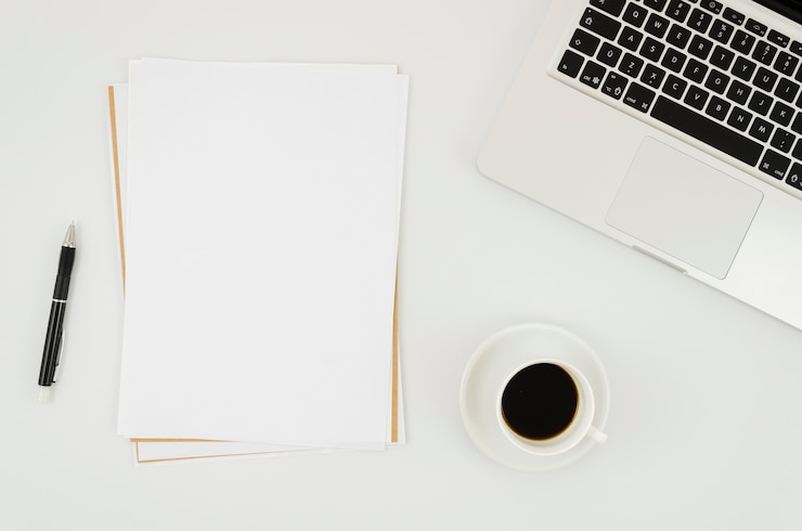 Free Photo flat lay paper mockup next to laptop