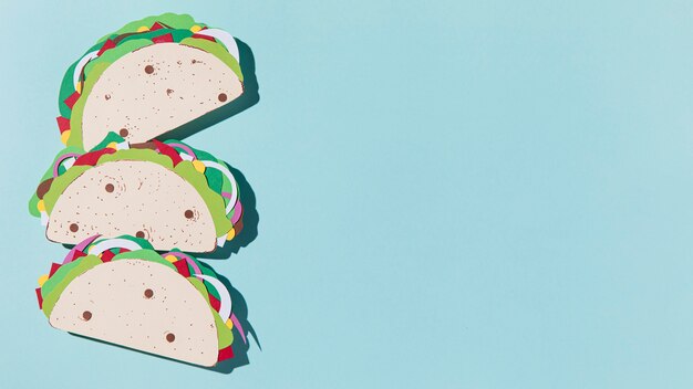 Flat lay paper tacos on blue background