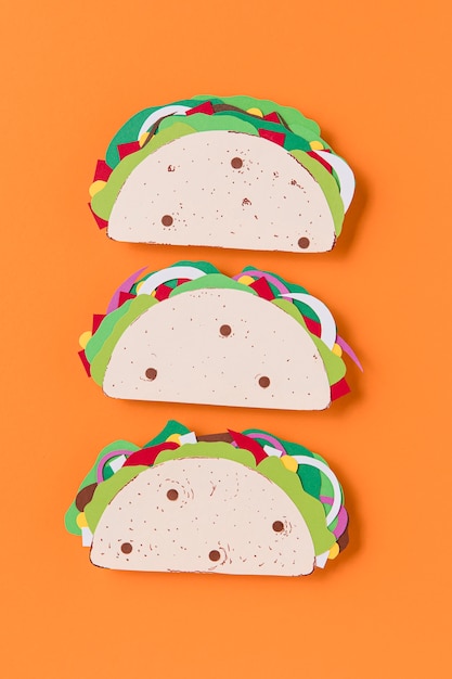 Flat lay paper tacos on orange background