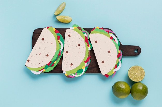 Flat lay paper tacos on wooden board