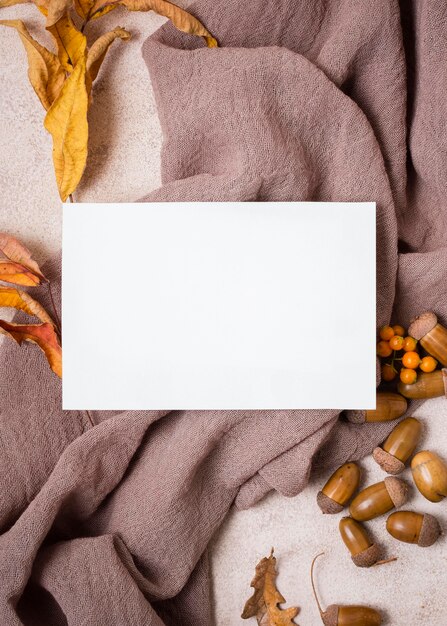 flat lay of paper with autumn leaves and acorns