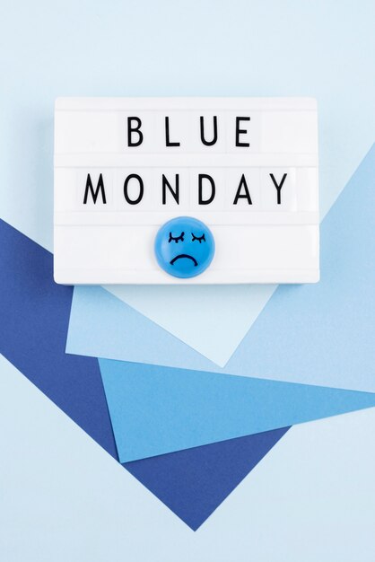 flat lay of paper with sad face for blue monday