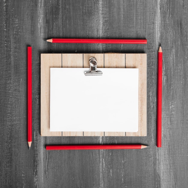 Flat lay of papers and clipboard on wooden table